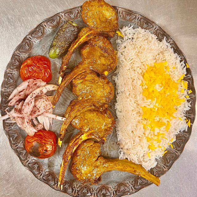 640 (1) side view of chicken kebab with onions and herbs on a wooden board